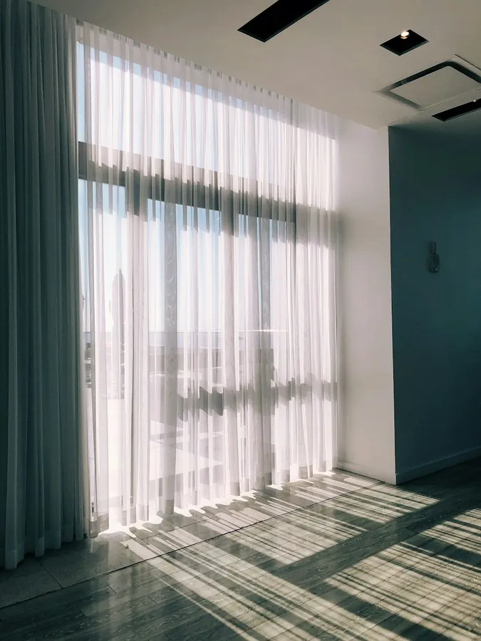 Sheer white curtains in a bright room