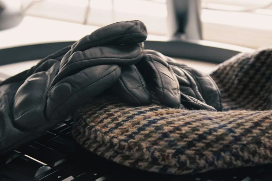 Black leather gloves resting on a tweed fabric