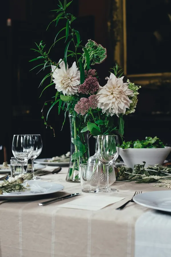 Laid dining table with a linen cloth and flowers
