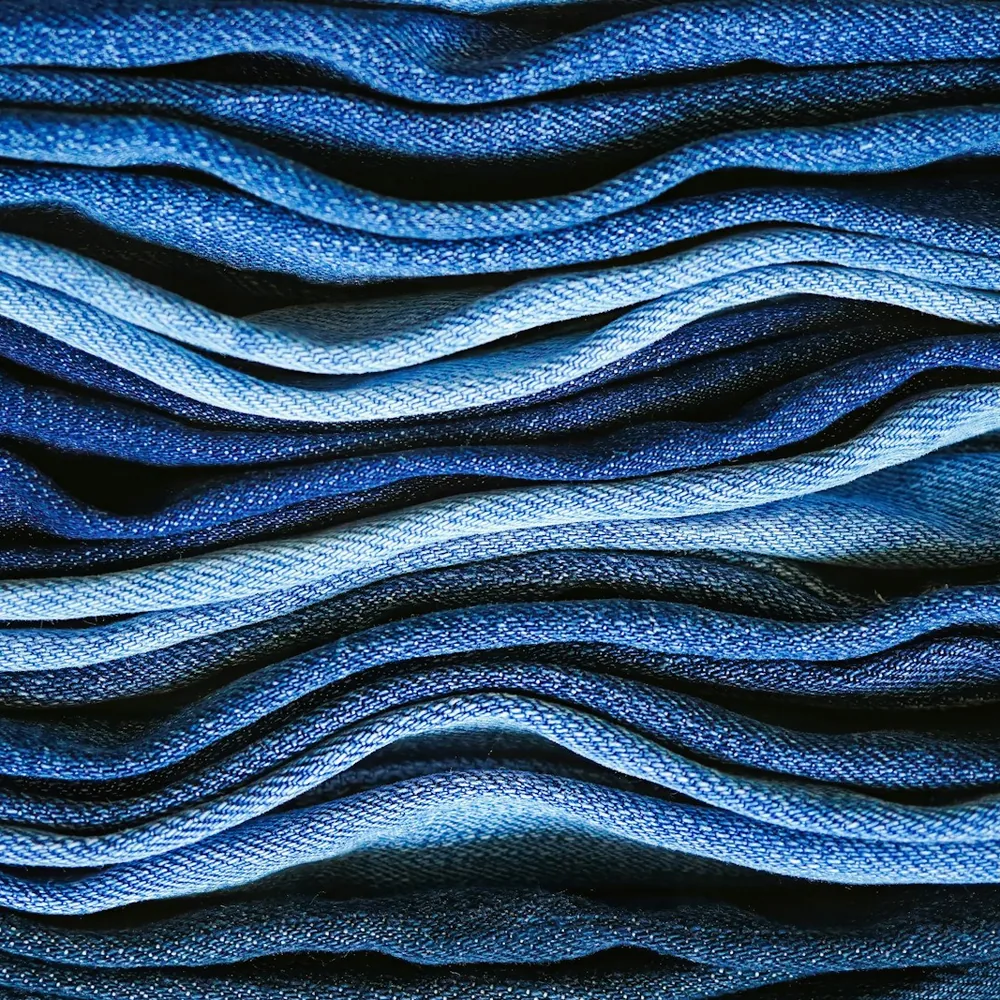 Close-up of folded denim in many shades of blue