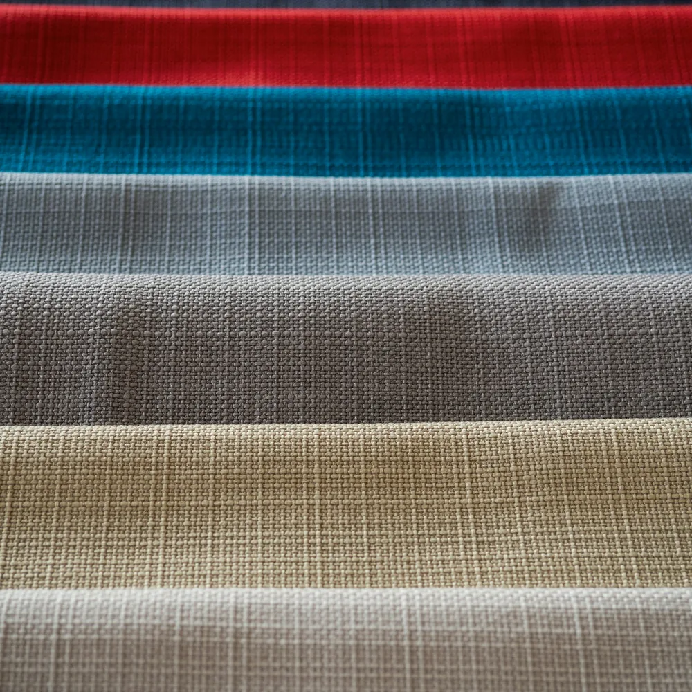 Woven fabric swatches in red, teal, grey and beige