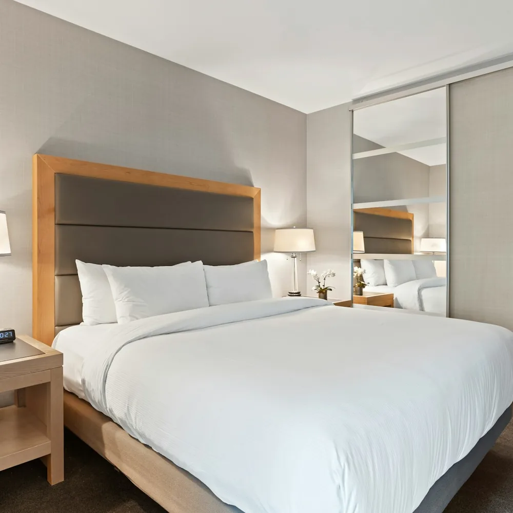 Bright hotel room with white bed linen