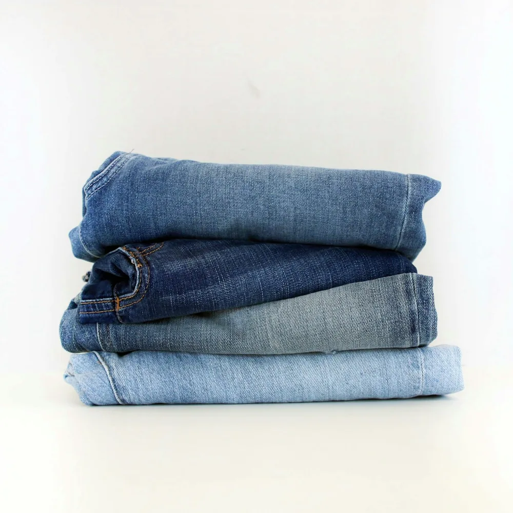 Stack of folded jeans in different washes