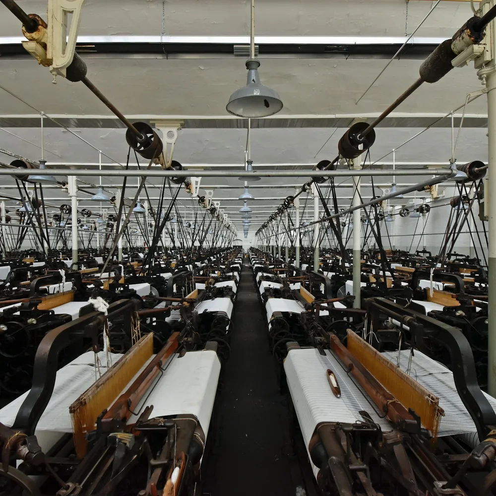 Rows of weaving looms in a textile mill