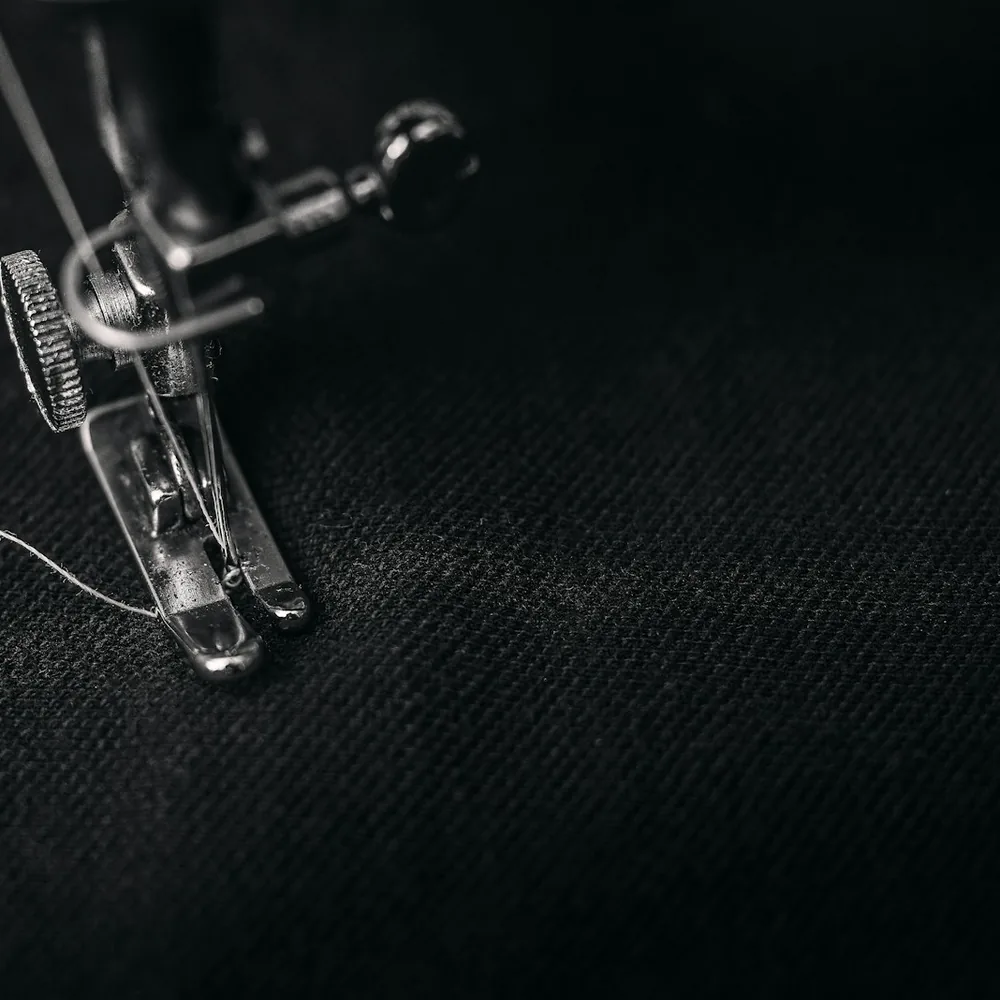 Sewing machine stitching dark fabric