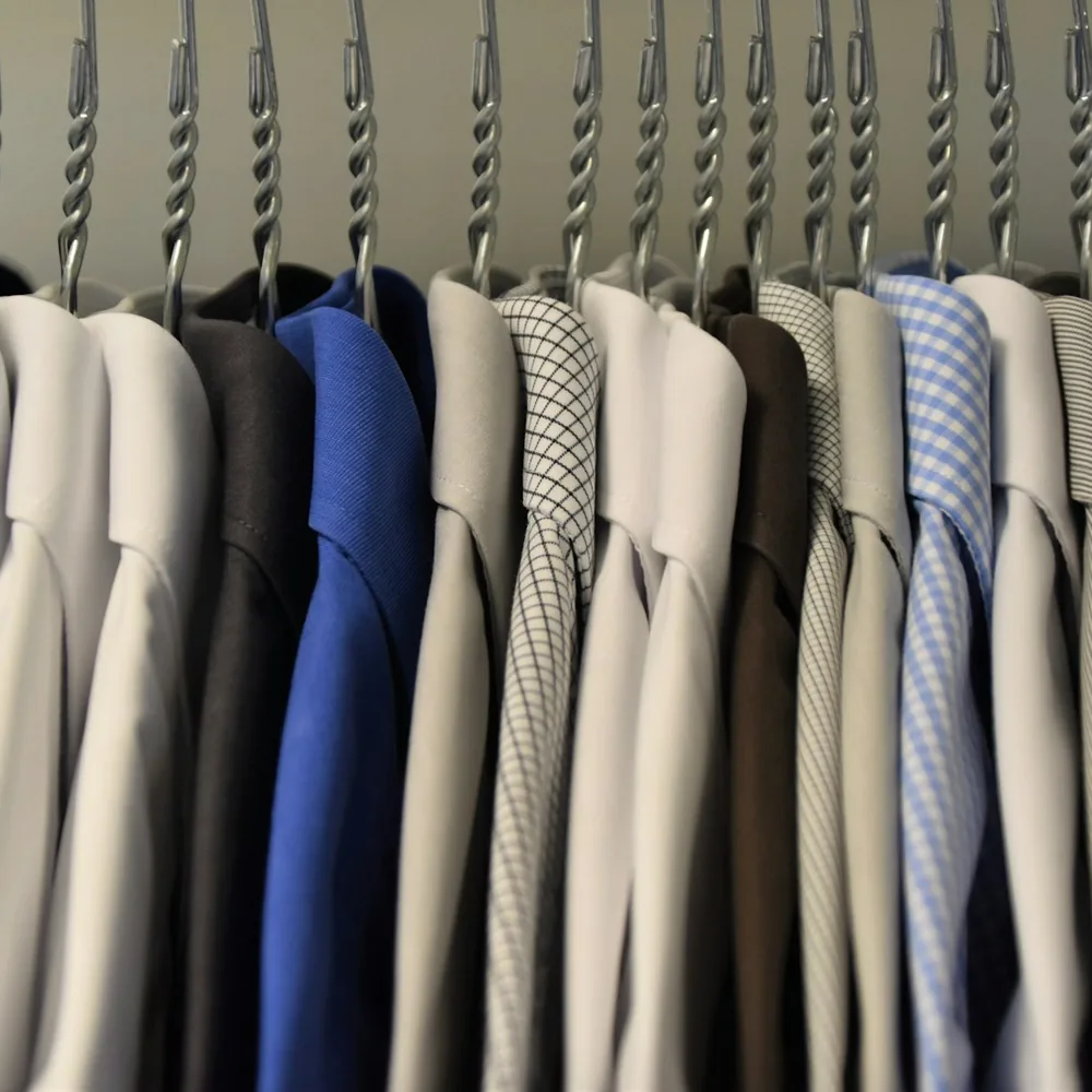 Woven and knitted shirts on hangers
