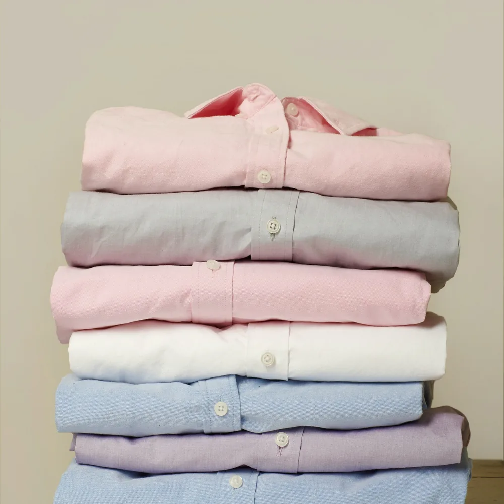 Stack of folded pastel oxford shirts