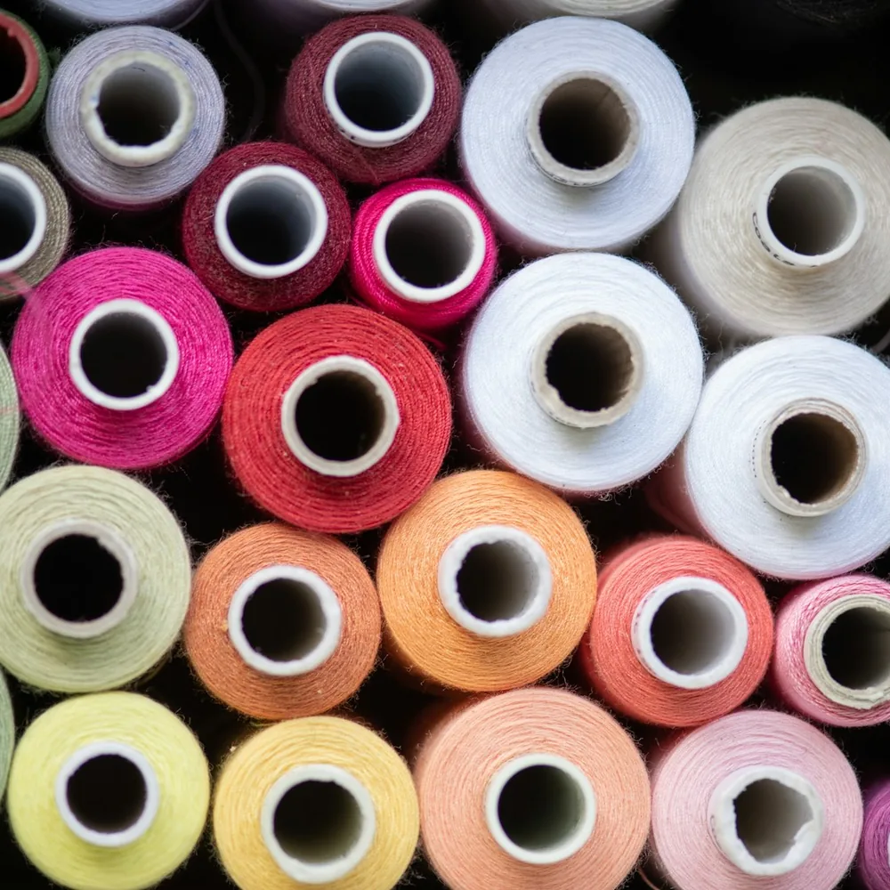 Cones of dyed yarn in many colours