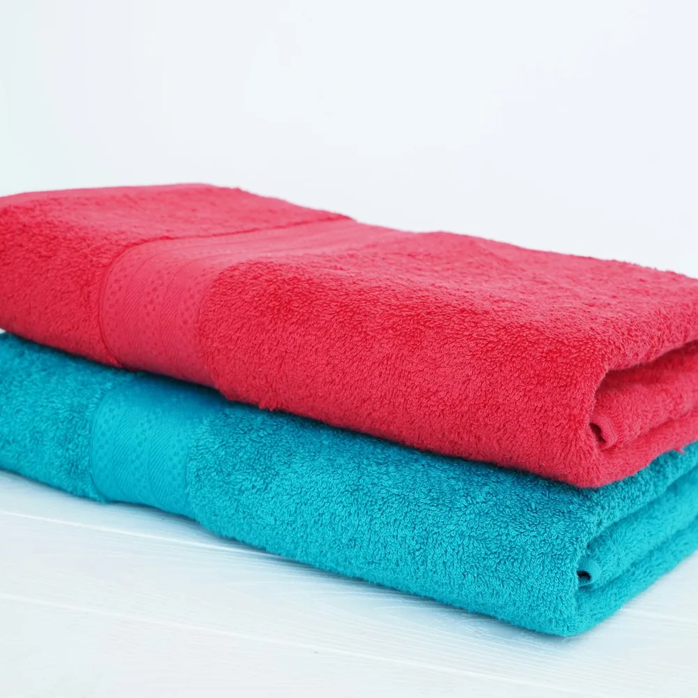 Folded terry towels in red and teal
